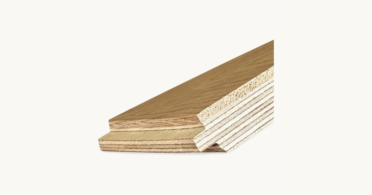 Cut-away of a 2-layer engineered board showing the oak face bonded to a plywood core, with the tongue and groove profile