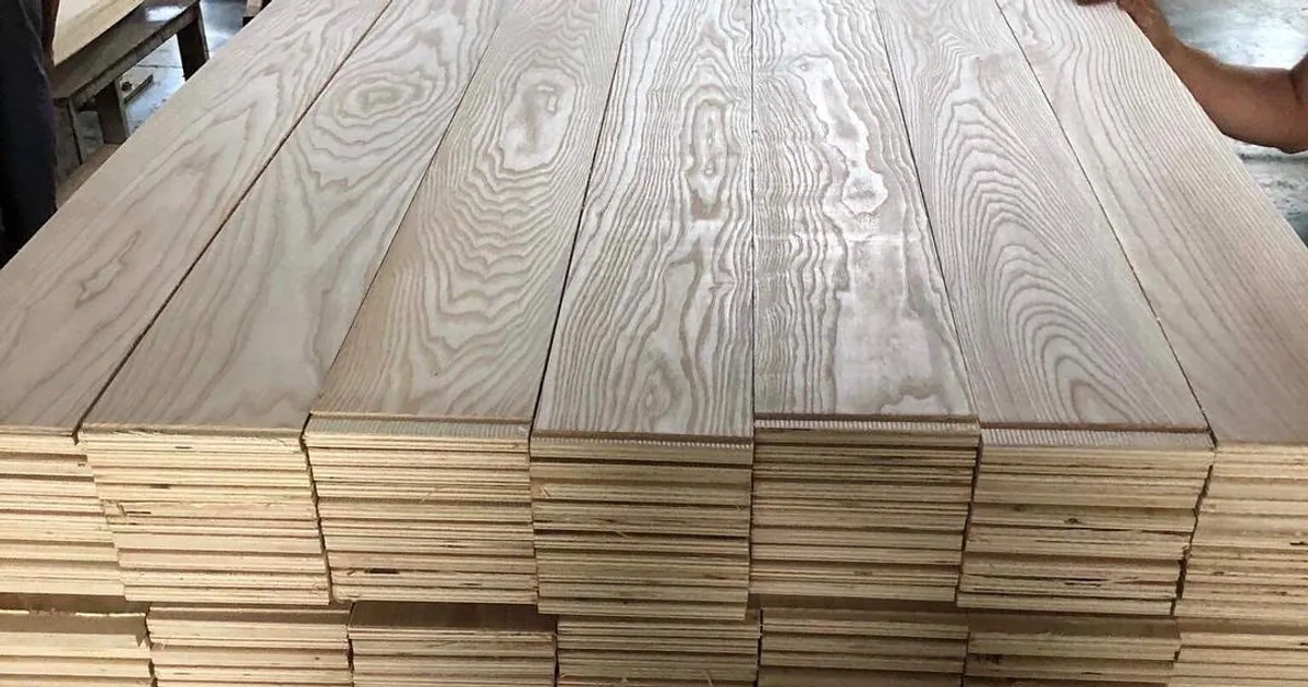Stack of engineered boards seen from the end, with a wood face over layered plywood plies