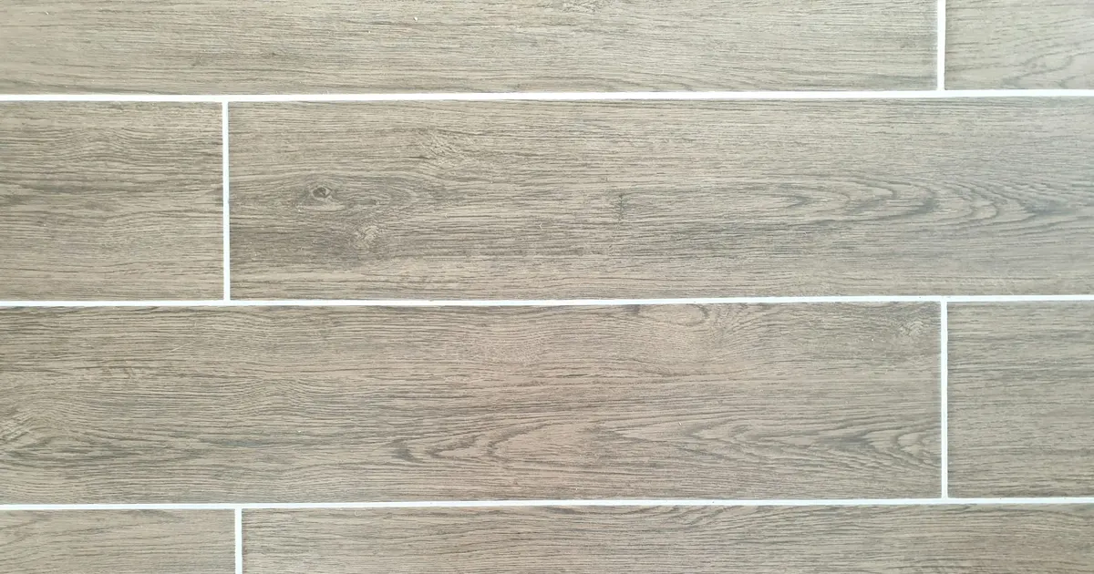 Wood-look porcelain tile laid in a running pattern with light grout lines