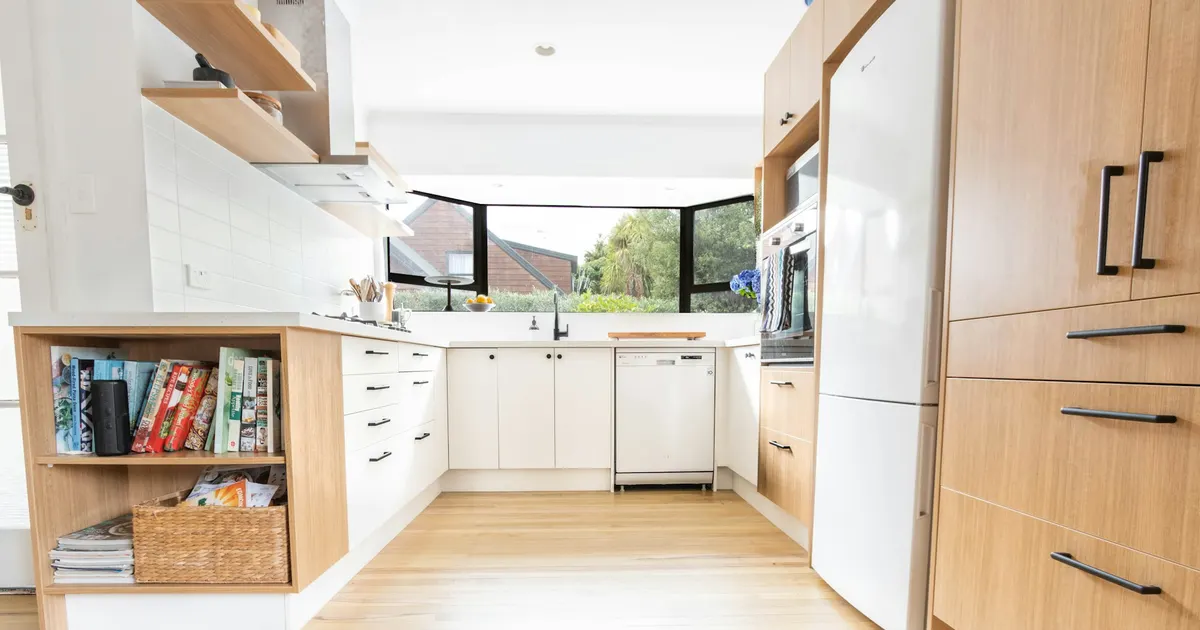 Kitchen with light wood cabinets and a natural wood floor